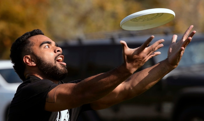 (Steve Griffin  |  The Salt Lake Tribune)  Steve Pikula, tech support manager for Xima Software, grabs a long pass as fellow employees play a game of Ultimate Frisbee during lunchtime on River Front Parkway in South Jordan Friday October 13, 2017.
