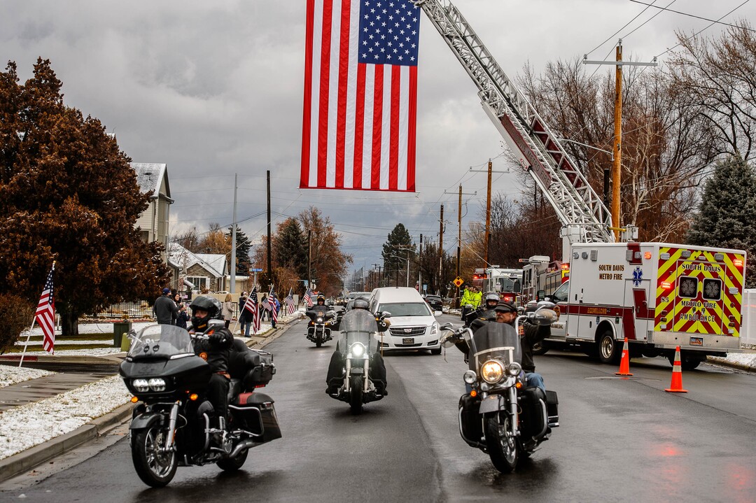 (Trent Nelson  |  The Salt Lake Tribune)
The procession passes under a large flag before services for Marine Pfc. Robert J. Hatch at the Bountiful City Cemetery on Saturday, Dec. 14, 2019. Hatch was killed in action Nov. 22, 1943 on the island of Betio.