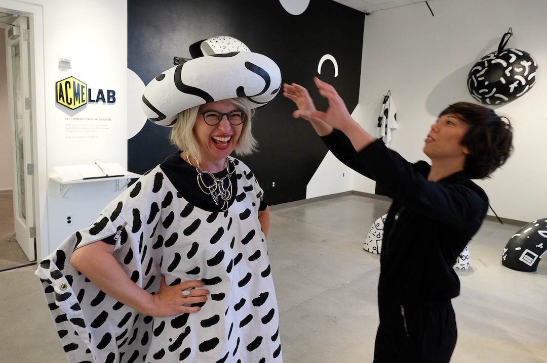 (Francisco Kjolseth  |  The Salt Lake Tribune)  Artist Lisa Iglesias, right, outfits Gretchen Dietrich, executive director of the Utah Museum of Fine Arts, with interactive art in the ACME Lab. The museum's new community space is designed for creative experimentation where visitors are encouraged to engage with art in fun new ways.