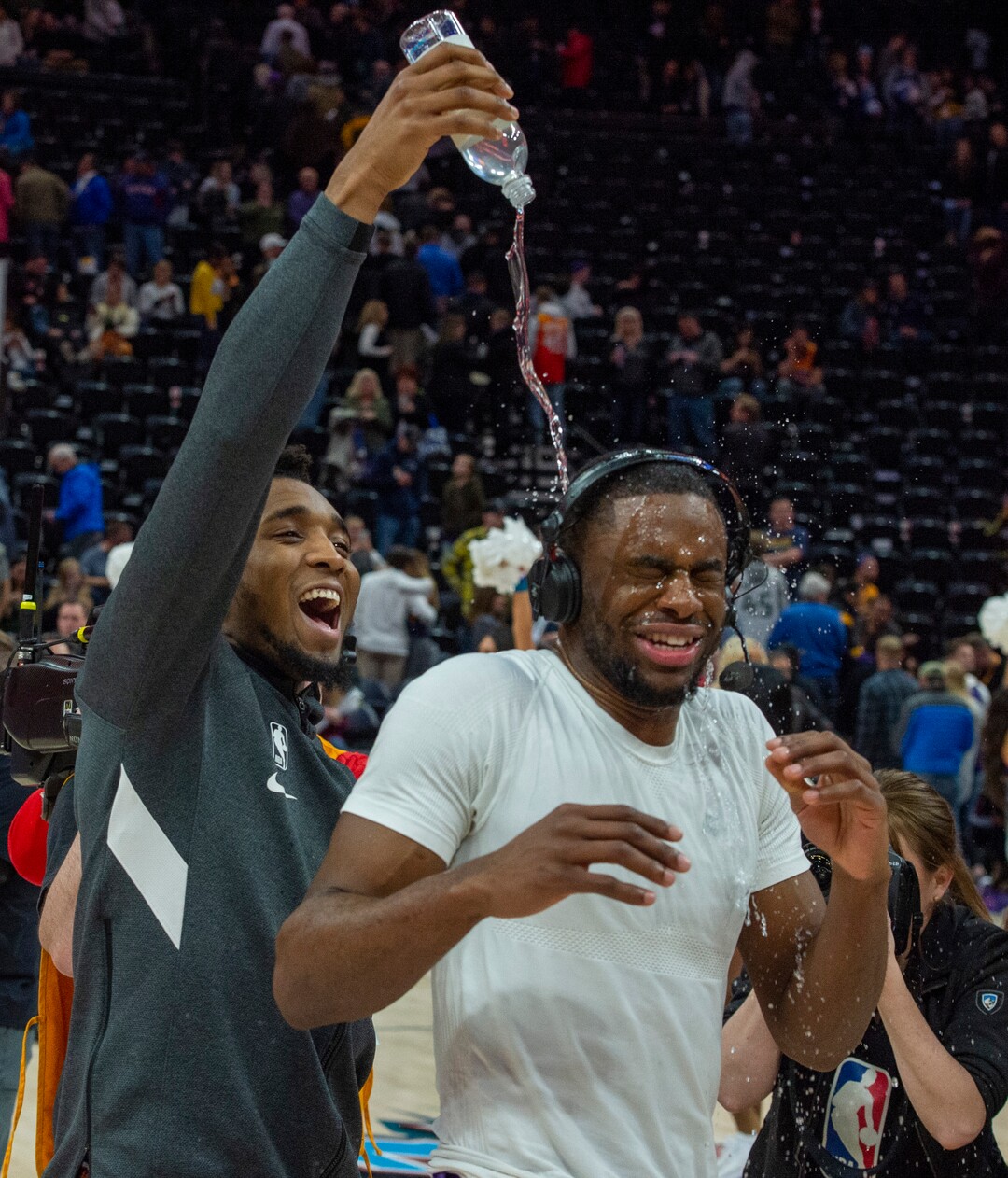 (Rick Egan  |  The Salt Lake Tribune) Utah Jazz guard Donovan Mitchell (45) pours water on Utah Jazz guard Emmanuel Mudiay (8) during a post game interview after the Utah Jazz defeated the New York Knicks 128-104, in NBA action in Salt Lake City, Wednesday, Jan. 8, 2020.