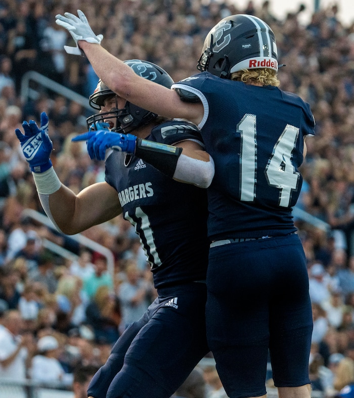 (Rick Egan | The Salt Lake Tribune) Corner Canyon wide receiver Jett Meine (11) and Hudson Greaves (14) celebrate a touchdown for the Chargers, in prep football action between the Corner Canyon Chargers and the Bingham Miners, on Friday, Aug. 27, 2021.