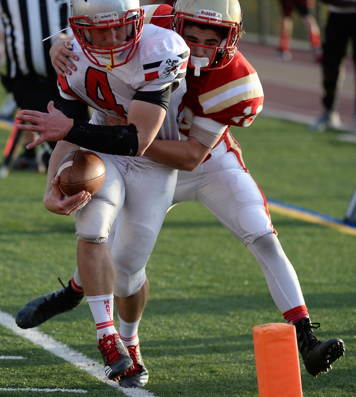 (Francisco Kjolseth  |  The Salt Lake Tribune)  Lance Fowles of Manti sets up his team for a touchdown as he's pressured by Alex Snarr of Judge in the Class 3A football playoff game on Thursday, Oct. 19, 2017. 