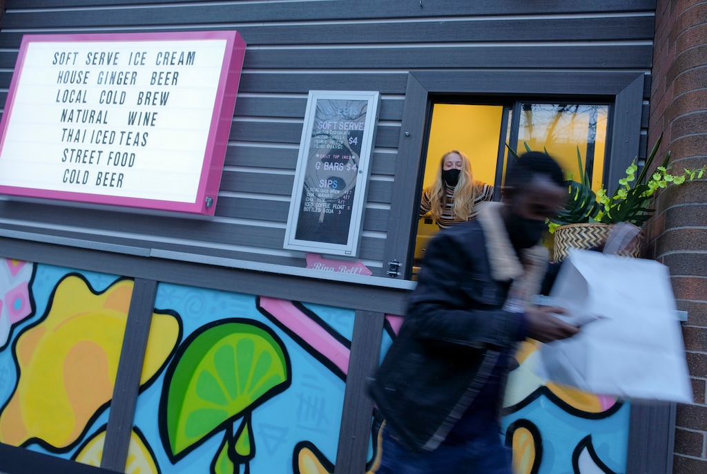 (Leah Hogsten | The Salt Lake Tribune) Ginger Street server Jess Zollinger hands out walk-up orders at the restaurant's takeout window located on State Street, Feb. 5, 2021. The restaurant is favorite takeout spot for Salt Lake City Mayor Erin Mendenhall.