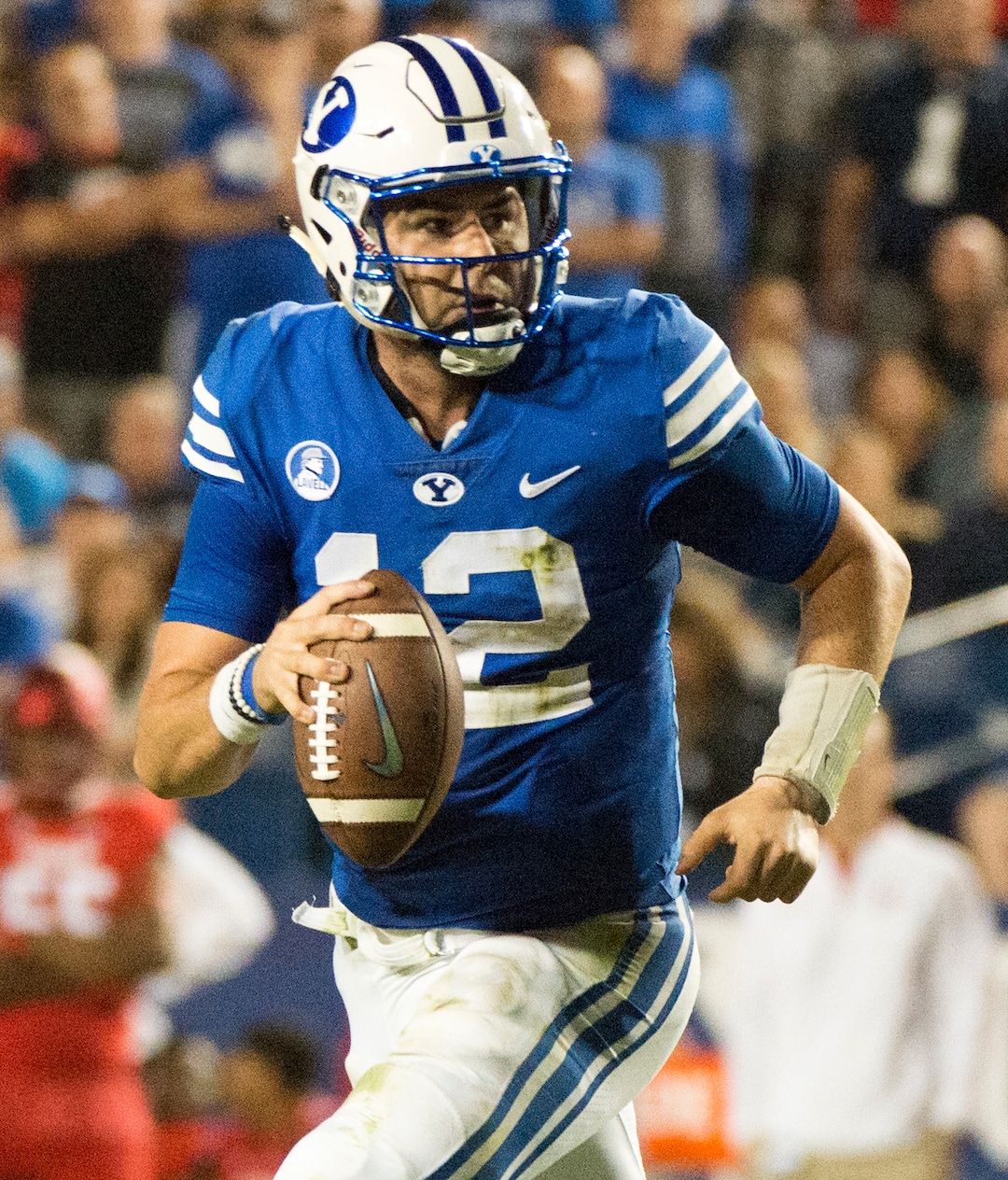 (Rick Egan  |  The Salt Lake Tribune)  Brigham Young Cougars quarterback Tanner Mangum (12) scrambles with the ball, in football action BYU vs. Utah,  at Lavell Edwards Stadium in Provo, Saturday, September 9, 2017.
