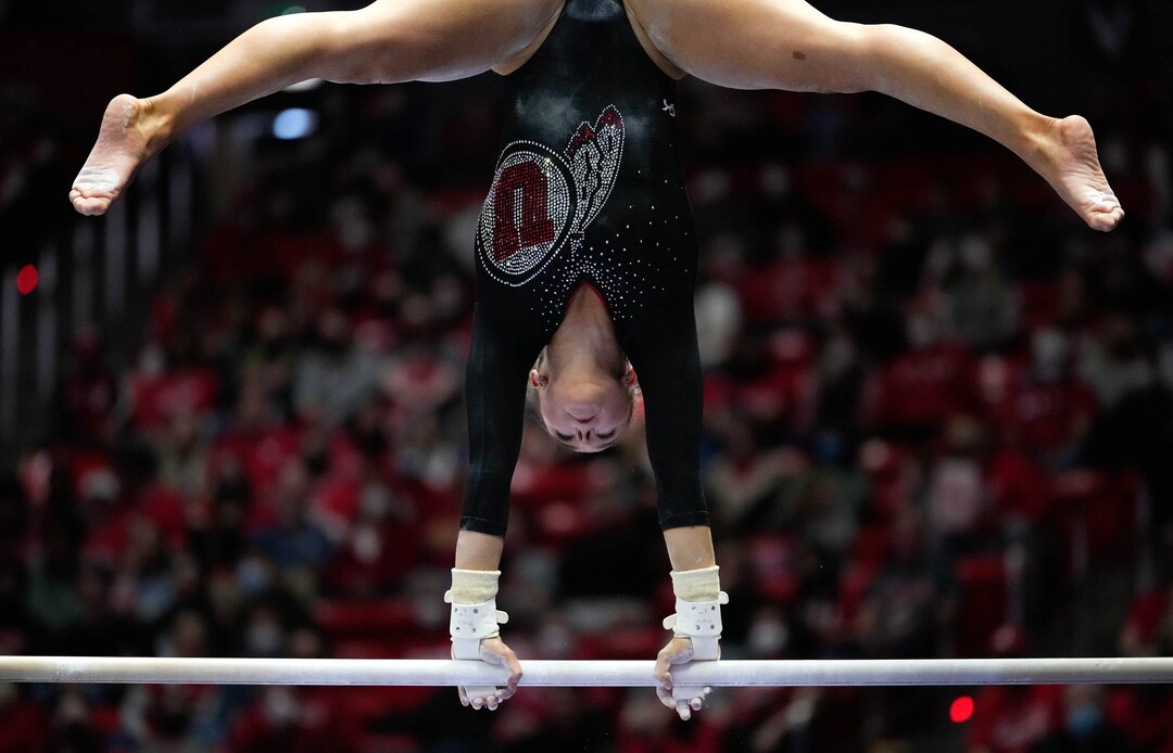 (Francisco Kjolseth | The Salt Lake Tribune) Utah’s Maile O’Keefe spins on the bars during their gymnastics meet with Stanford at the Huntsman Center in Salt Lake City, Saturday, Jan. 29, 2022.
