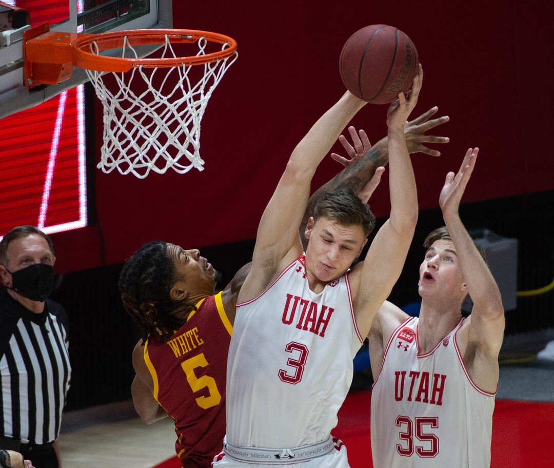 (Francisco Kjolseth  | The Salt Lake Tribune) Utah Utes guard Pelle Larsson (3) and Utah Utes center Branden Carlson (35) take on USC Trojans guard Isaiah White (5) for a rebound in PAC-12 basketball action at the Jon M. Huntsman Center, on Saturday, Feb. 27, 2021.