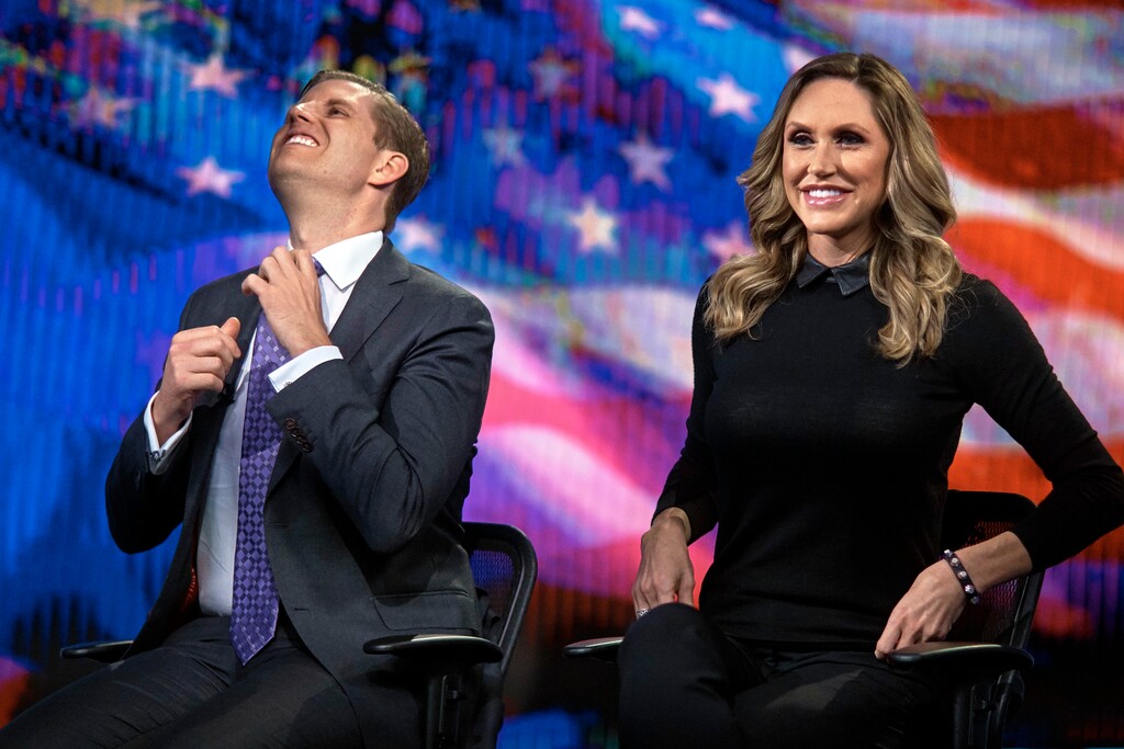 (Andres Kudacki | The Associated Press) In this Oct. 13, 2017, file photo, Eric Trump, left, fixes his tie as Lara Trump, right, smiles while they tape a segment of "Justice With Judge Jeanine," at the Fox Studios in New York. The re-election campaign of President Donald Trump has already sprung to life two-and-a-half years before his name appears again on any ballot. The campaign is pushing its own online news source to counteract what it believes is an oppositional media. And its face is a rising star in the president's orbit: his daughter-in-law Lara Trump.