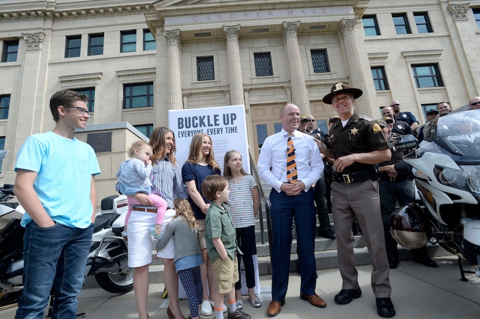 Al Hartmann photo
UHP's Col. Daniel Fuhr, right, congratulates Justin Harding, Governor Herbert’s Chief of Staff for wearing seatbelts at a press conference Monday May 23 at Libby Gardner Hall. The Harding family was on their way to the hall for music rehearsal with his family when a car turned in front of them and hit them head on. He credits the decision of wearing seat belts, booster and infant car seats for saving his life and the lives of his four children. They were shaken up but mostly uninjured. Harding, his family and members of law enforcement were there to encourage seat belt use. Utah kicks off its annual Click It or Ticket campaign to promote seat belt use starting today.