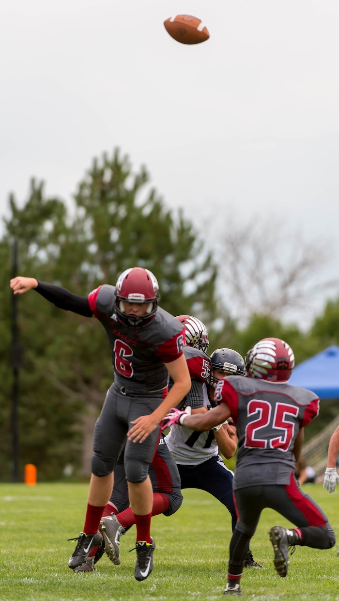 Trent Nelson  |  The Salt Lake TribuneLayton Christian quarterback Grayson Jackson loses a very high snap while facing Duchesne, high school football in Layton Thursday August 21, 2014.