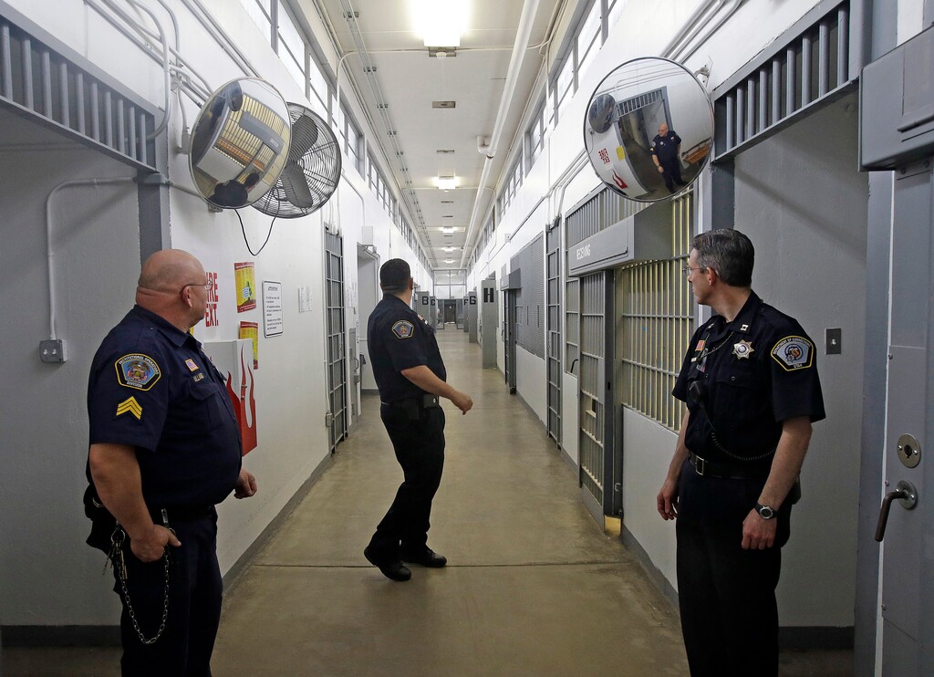 Department of Corrections Officers are shown in the Uinta 5 receiving and orientation unit during a media tour Thursday, Feb. 26, 2015, at the Utah State Correctional Facility in Draper, Utah. Gov. Gary Herbert said Thursday that he's opposed to the idea of allowing a state commission to pick a location to build a new prison instead of leaving the decision with the Legislature. (AP Photo/Rick Bowmer, Pool)