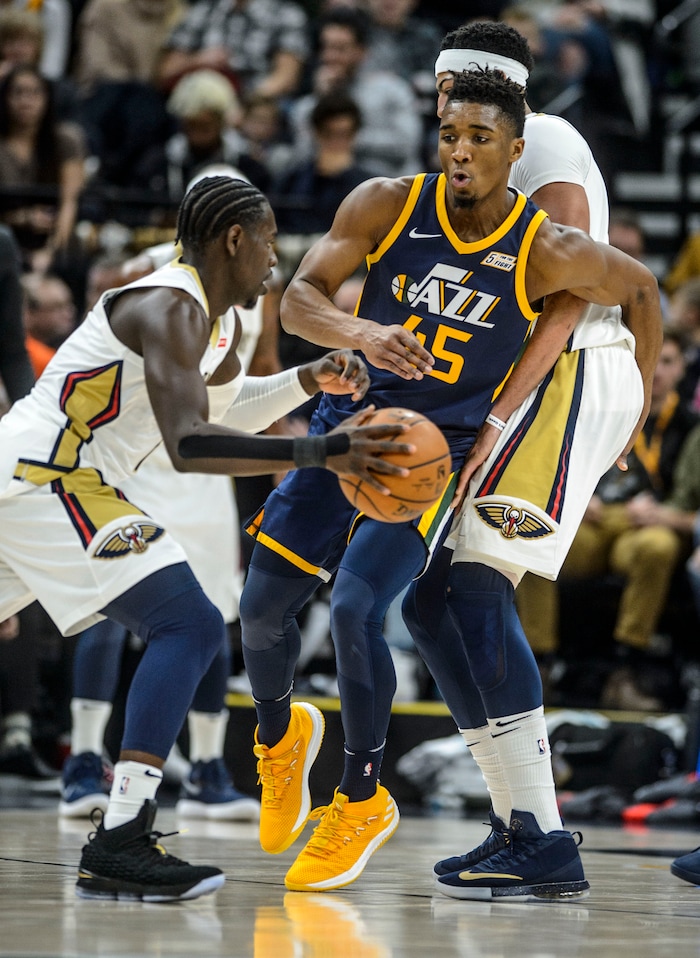 (Steve Griffin  |  The Salt Lake Tribune) Utah Jazz guard Donovan Mitchell (45) sneaks past a green set by New Orleans Pelicans forward Anthony Davis (23) during the the Utah Jazz versus the New Orleans Pelicans NBA basketball game at the Vivint Smart Home Arena in Salt Lake City Wednesday January 3, 2018.