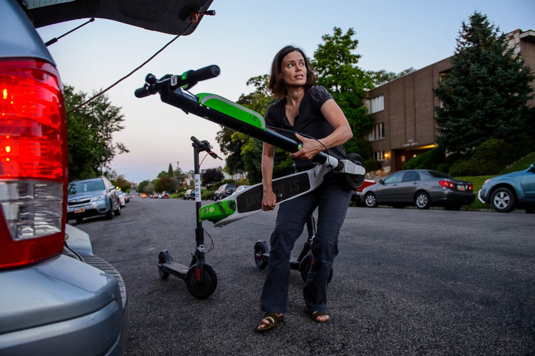 (Trent Nelson | The Salt Lake Tribune) Jenn Hein unloads scooters in Salt Lake City early Wednesday Aug. 8, 2018. Hein works as a "Bird charger" on the side to make some extra cash, picking up and charging electric scooters overnight and returning them to the city streets in the early morning.