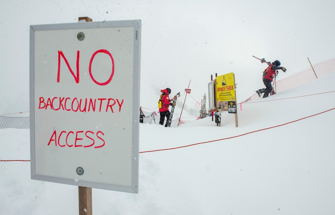 (Rick Egan | The Salt Lake Tribune)  Park City Mountain Resort ski patrollers hike the boot-pack path toward the ski area exit gate on the ridge above the Ninety-Nine 90 lift. Access to the gate has been closed since two men died in January in avalanches in the adjacent unmaintained backcountry areas after leaving the resort through that point.Wednesday, Feb. 24, 2021.