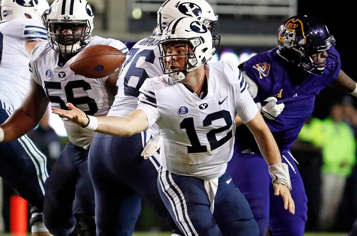 Brigham Young's Tanner Mangum (12) loses control of the ball during the second half of an NCAA college football game against East Carolina in Greenville, N.C., Saturday, Oct. 21, 2017. (AP Photo/Karl B DeBlaker)