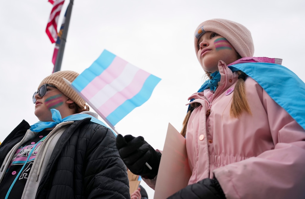 (Bethany Baker  |  The Salt Lake Tribune) Cora Gardner, right, who identified as an LGBTQ ally, holds a transgender pride flag as she listens during the Rally for Trans Community Support at the Capitol in Salt Lake City Friday, Jan. 24, 2025.