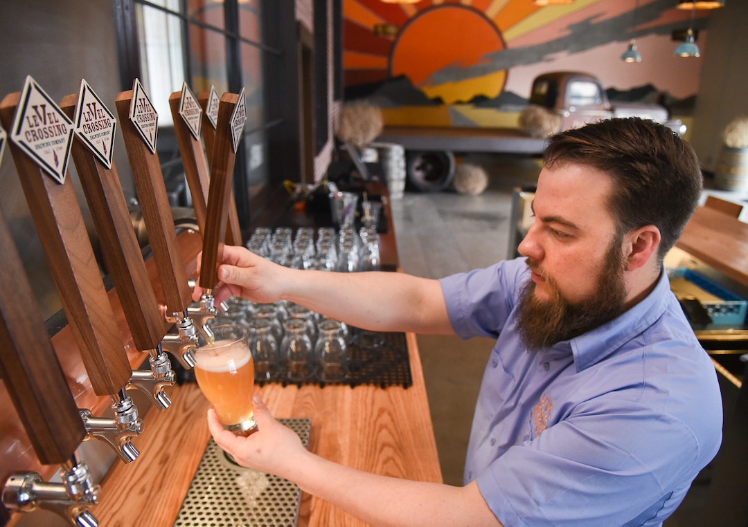 (Francisco Kjolseth  |  The Salt Lake Tribune)  Chris Detrick, head brewer for Level Crossing Brewing Co. pours one of four new beers on tap.
