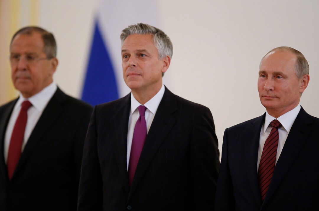 Russian President Vladimir Putin, right, smiles receiving credentials from the U.S. Ambassador, Jon Huntsman, center, during a ceremony in the Kremlin in Moscow, Russia, on Tuesday, Oct. 3, 2017. The new U.S. Ambassador to Russia presented his credentials to President Vladimir Putin in the Kremlin on Monday amid investigations into Moscow's meddling in the 2016 U.S. elections. Russian Foreign Minister Sergey Lavrov is at left. (AP Photo/Pavel Golovkin, Pool)