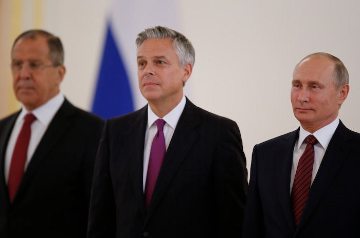 Russian President Vladimir Putin, right, smiles receiving credentials from the U.S. Ambassador, Jon Huntsman, center, during a ceremony in the Kremlin in Moscow, Russia, on Tuesday, Oct. 3, 2017. The new U.S. Ambassador to Russia presented his credentials to President Vladimir Putin in the Kremlin on Monday amid investigations into Moscow's meddling in the 2016 U.S. elections. Russian Foreign Minister Sergey Lavrov is at left. (AP Photo/Pavel Golovkin, Pool)