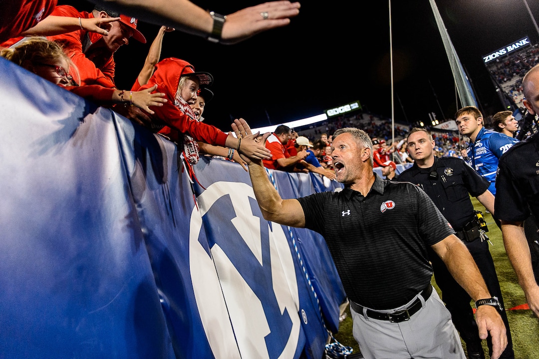 (Trent Nelson | The Salt Lake Tribune)  Utah Utes head coach Kyle Whittingham high-fives fans after the win as BYU hosts Utah, NCAA football in Provo, Saturday September 9, 2017.