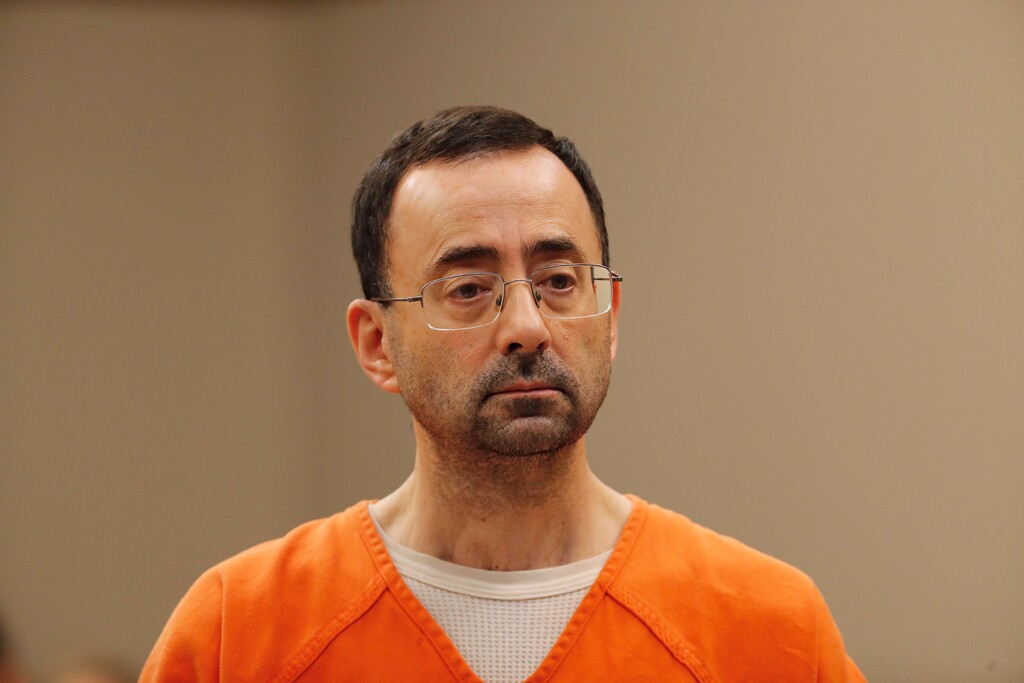 (Paul Sancya | The Associated Press) Dr. Larry Nassar, 54, appears in court for a plea hearing in Lansing, Mich., Wednesday, Nov. 22, 2017. Nasser, a sports doctor accused of molesting girls while working for USA Gymnastics and Michigan State University, pleaded guilty to multiple charges of sexual assault and will face at least 25 years in prison.