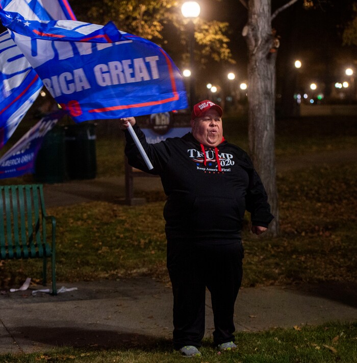 (Rick Egan | The Salt Lake Tribune)  Trump supporters don't bother wearing masks as they yell at cars during a rally at Washington Square, on Monday, Nov. 2, 2020.