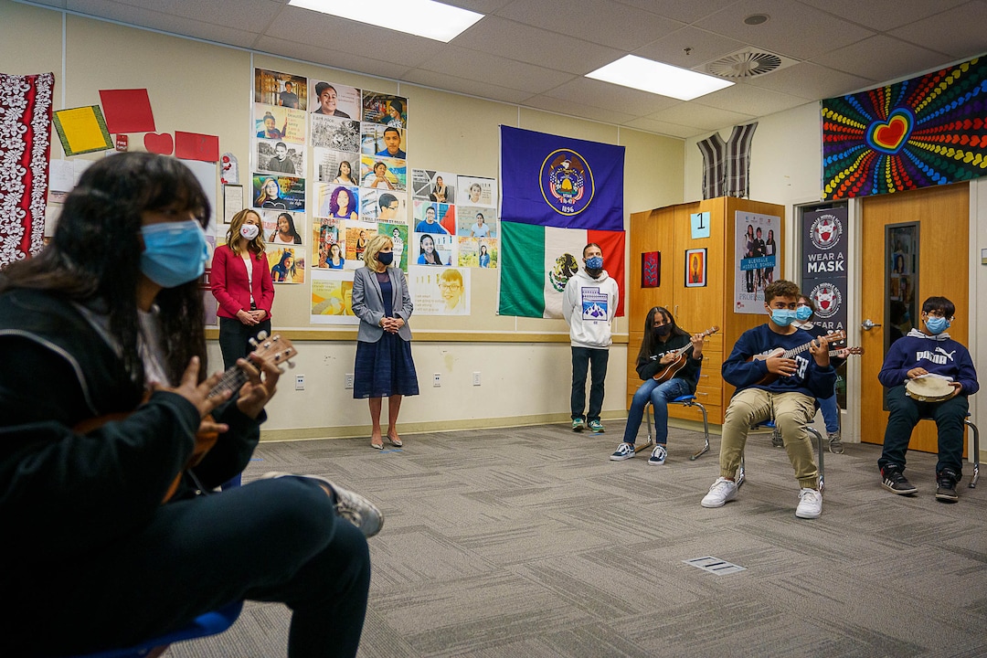(Trent Nelson  |  The Salt Lake Tribune) Abby Cox and Jill Biden listen to a performance by the Ukelele Club at Glendale Middle School in Salt Lake City on Wednesday, May 5, 2021. Teacher Dane Hess is at right.