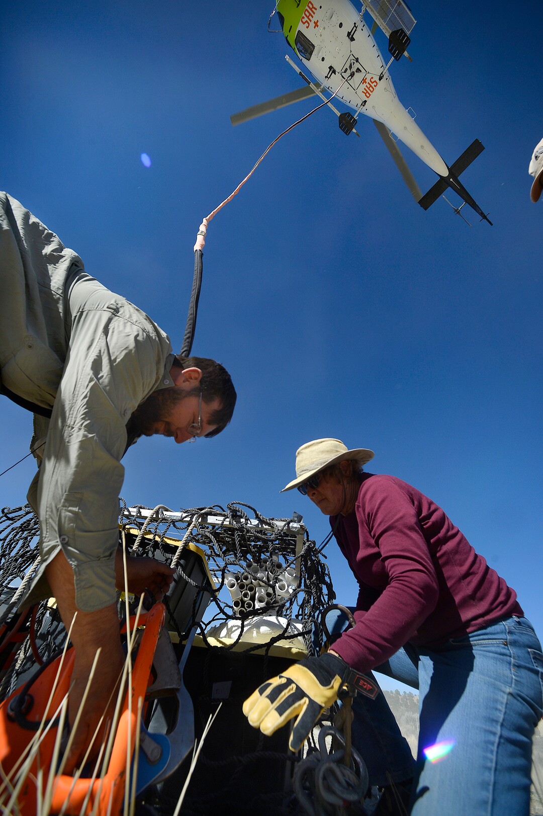 (Scott Sommerdorf   |  The Salt Lake Tribune)   Paleontologist Taylor Birthisel, left, and Jeanette Bonnell work to unhook the last of the loads airlifted from the site where BLM paleontologist Alan Titus discovered a nearly complete Tyrannosaurus Rex skeleton near Tropic, Utah, Sunday, October 15, 2017. 