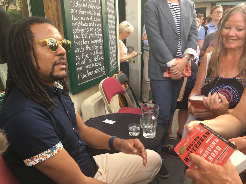In this June 20, 2017 photos, Novelist Colson Whitehead speaks to fans after discussing his Pulitzer prize-winning book "The Underground Railroad" at the English-language bookstore Shakespeare and Company in Paris. (AP Photo/Russell Contreras)