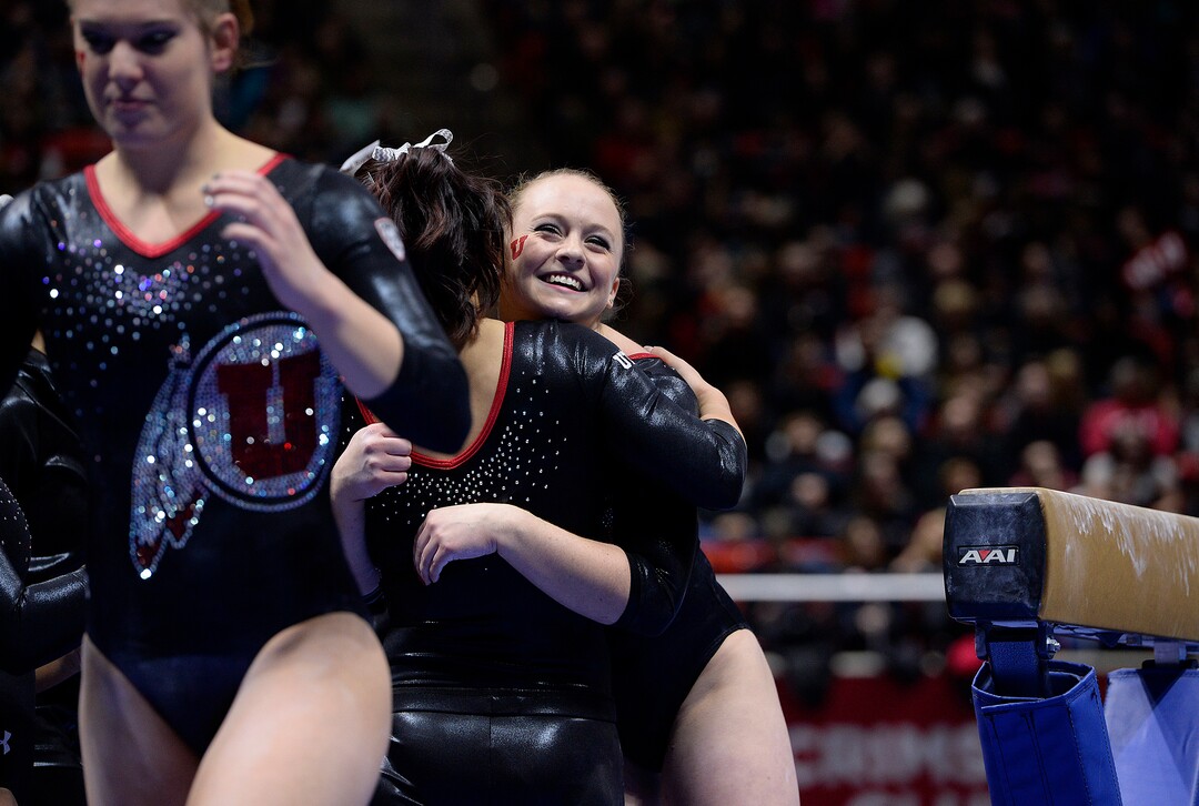 Scott Sommerdorf   |  The Salt Lake TribuneMaddy Stover gets hugs from team mates after her beam routine where she scored 9.850. Utah Gymnastics defeated UCLA 196.725 - 194.725 in the Huntsman Center, Friday, January 23, 2015. 