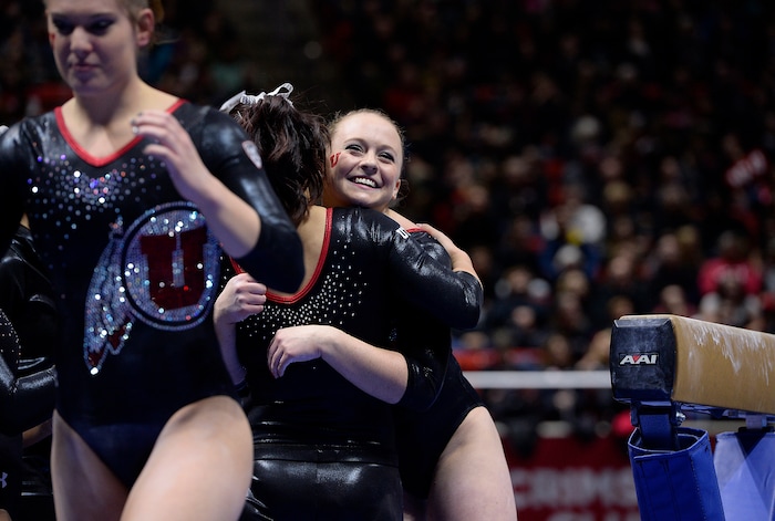Scott Sommerdorf   |  The Salt Lake TribuneMaddy Stover gets hugs from team mates after her beam routine where she scored 9.850. Utah Gymnastics defeated UCLA 196.725 - 194.725 in the Huntsman Center, Friday, January 23, 2015. 