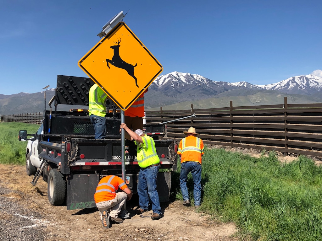(Photo courtesy of Utah Department of Transportation) Crews install new radar-triggered signs that flash warnings to motorists when wildlife is detected.