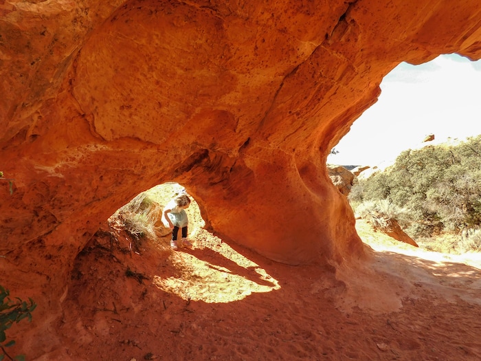 The Salt Lake Tribune|Erin Alberty
A hiker crawls into Babylon Arch on March 12, 2017 in the Red Cliffs Desert Reserve near Leeds.