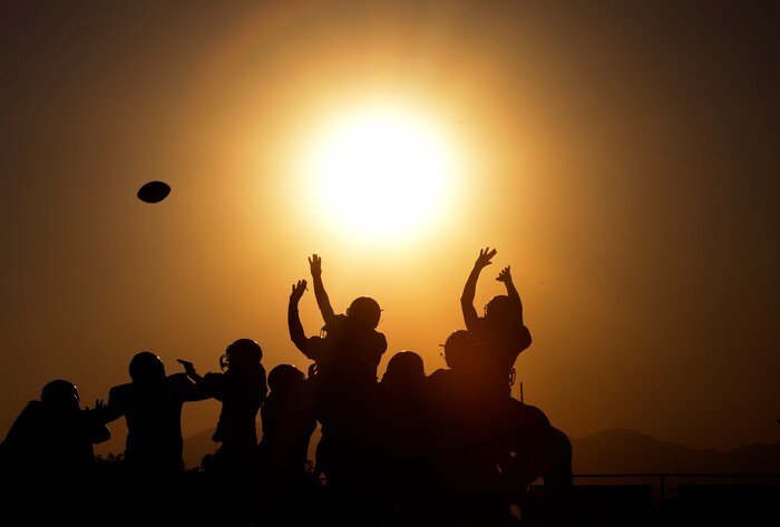 (Scott Sommerdorf | The Salt Lake Tribune) Pleasant Grove players try to block a Corner Canyon field goal attempt as the sun set late in the first half, Friday, August 18, 2017.