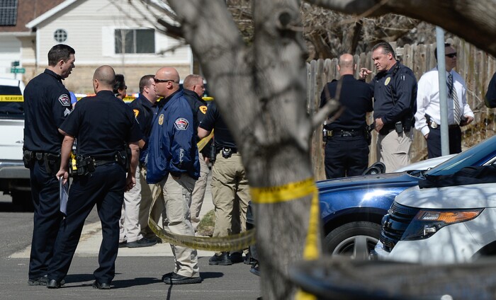 (Francisco Kjolseth | The Salt Lake Tribune) Investigators comb the scene where a Granite School District police officer shot a driver on Tuesday afternoon, March 20, 2018. While on patrol near Hunter High School, the officer noticed a car full of teenagers and smelled marijuana. When he approached the car lurched and he ended up on the hood. The driver was shot and four other teens in the car fled the scene.