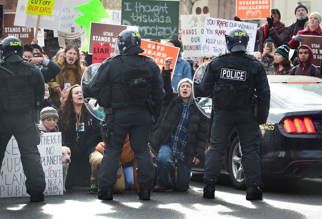 (Scott Sommerdorf   |  The Salt Lake Tribune)   Protestors shout "This is what democracy looks like!" as they confront SLCPD as they blocked State Street near 100 South after President Trump's visit to Salt Lake City, Monday, December 4, 2017.  