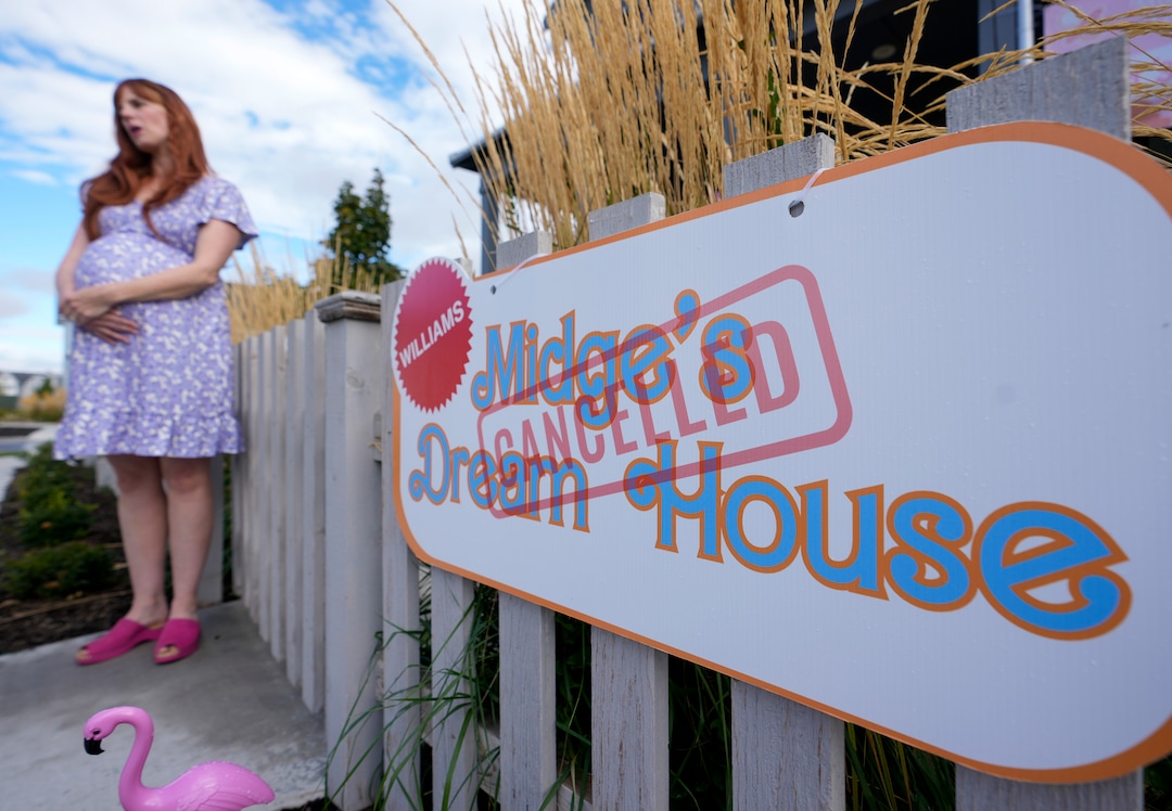 (Bethany Baker  |  The Salt Lake Tribune) Amy Williams, dressed as “Midge” from the movie “Barbie,” stands outside her decorated home in a section of Daybreak that has collectively created a Barbieland-themed community for Halloween on Wednesday, Oct. 11, 2023.