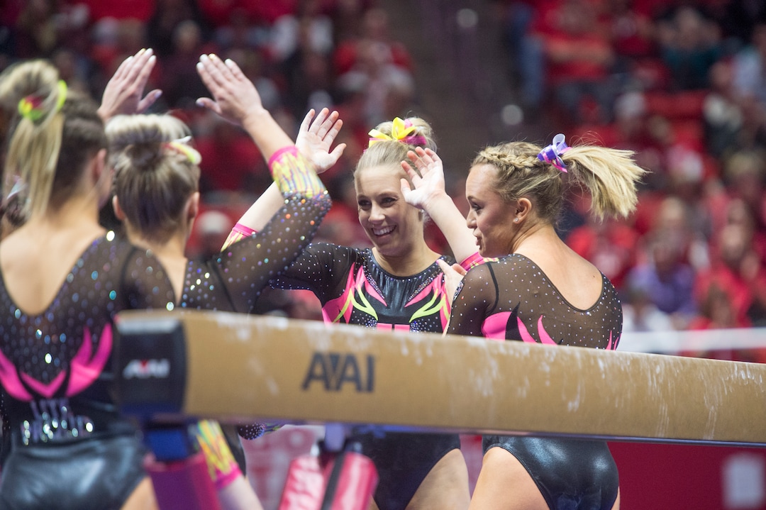 (Rick Egan  |  The Salt Lake Tribune)   Team mates congratulate MaKenna Merrell-Giles after her performance on the beam for Utah, in Gymnastics action Utah vs. Oregon State at the Jon M. Huntsman Center, Friday, January 19, 2018.