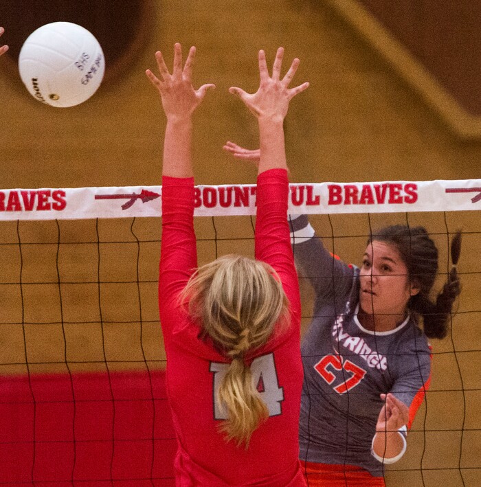 (Rick Egan  |  The Salt Lake Tribune)  Naomi Pulu (27), Skyridge, hits the ball past Hannah Howard (3), and Bri Mortensen, 14, Bountiful, in volleyball action, Bountiful vs. Skyridge, at Bountiful High, Wednesday, September 6, 2017.