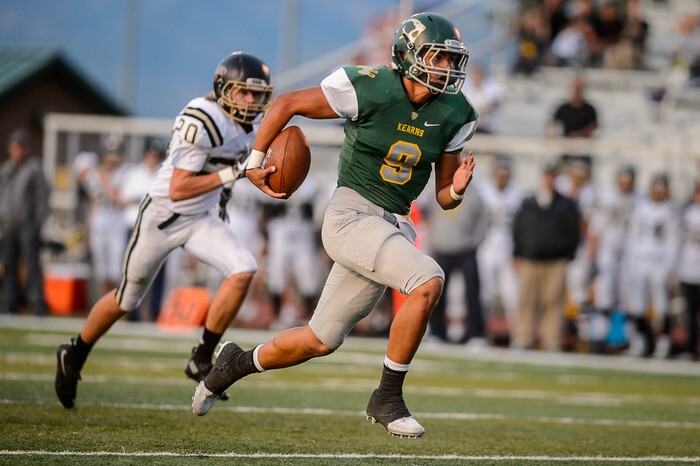 (Trent Nelson | The Salt Lake Tribune) Kearns quarterback Camden Wilbur runs for a touchdown as Kearns hosts Lone Peak, high school football, Thursday September 14, 2017.