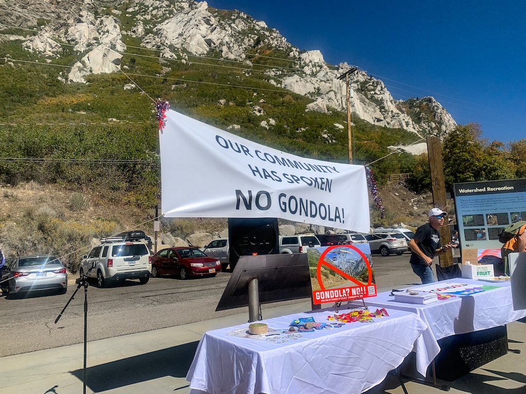 (Jordan Miller | The Salt Lake Tribune) An anti-gondola banner displayed by protestors at the Little Cottonwood Canyon Park and Ride on Saturday, September 25, 2021.