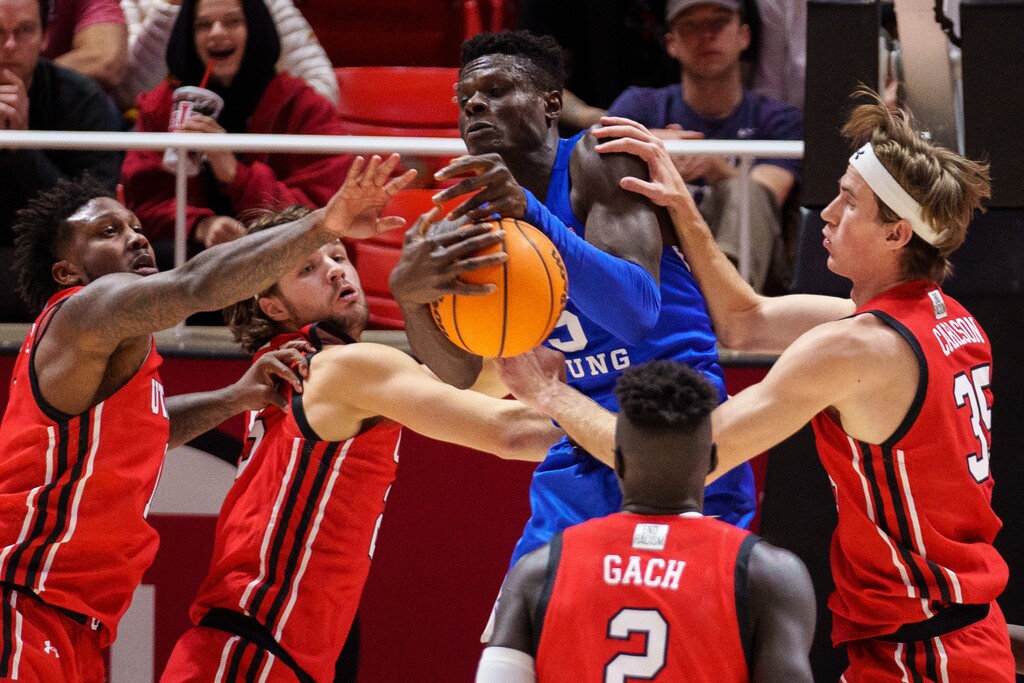 (Trent Nelson  |  The Salt Lake Tribune) Brigham Young Cougars forward Gideon George (5) rebounds as the Utah Utes host BYU, NCAA basketball in Salt Lake City on Saturday, Nov. 27, 2021.