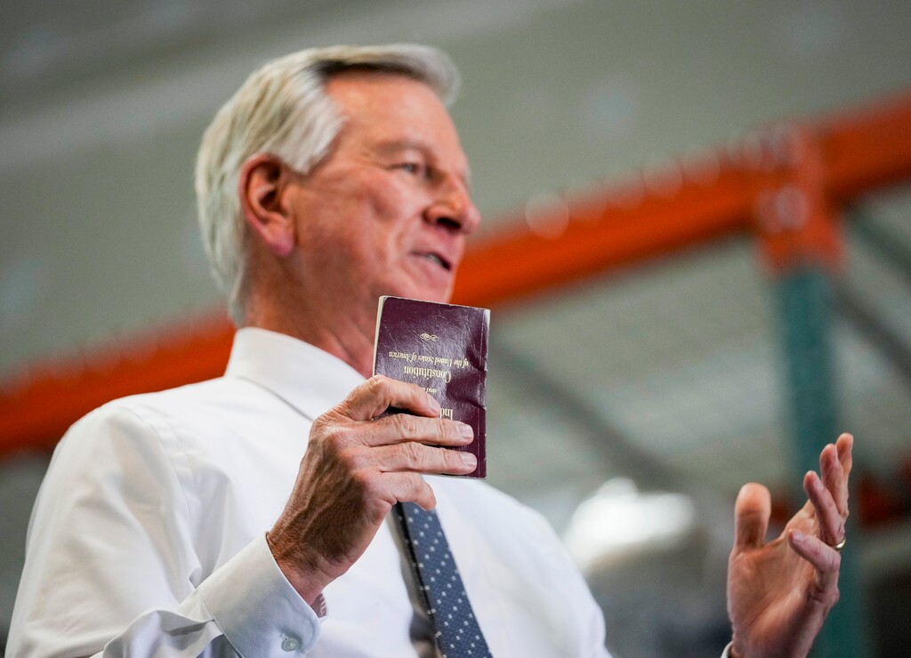 (Bethany Baker | The Salt Lake Tribune) Alabama Sen. Tommy Tuberville holds up a copy of the U.S. Constitution as he speaks before a crowd during a campaign event for Republican U.S. Senate candidate Trent Staggs in Bluffdale on Friday, March 15, 2024.