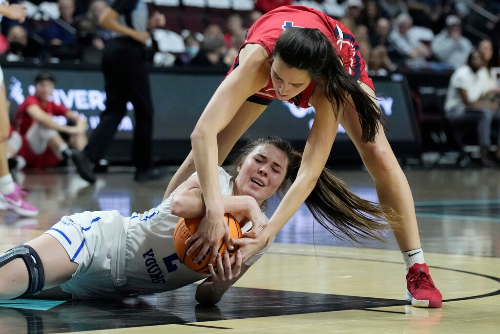BYU's Shaylee Gonzales, left, and Gonzaga's Abby O'Connor (4) scramble for the ball during the first half of an NCAA women's championship college basketball game at the West Coast Conference tournament Tuesday, March 8, 2022, in Las Vegas. (AP Photo/John Locher)