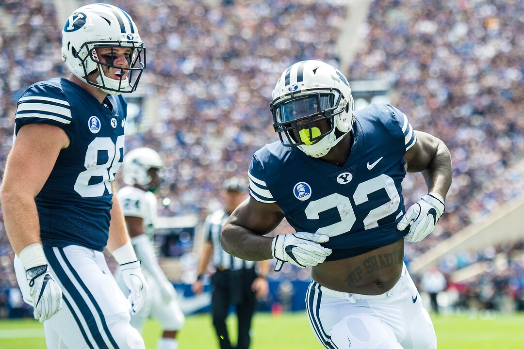 (Chris Detrick  |  The Salt Lake Tribune) Brigham Young Cougars running back Squally Canada (22) celebrates after scoring a touchdown during the game at LaVell Edwards Stadium Saturday, August 26, 2017. Brigham Young Cougars tight end Tanner Balderree (88) is at left.