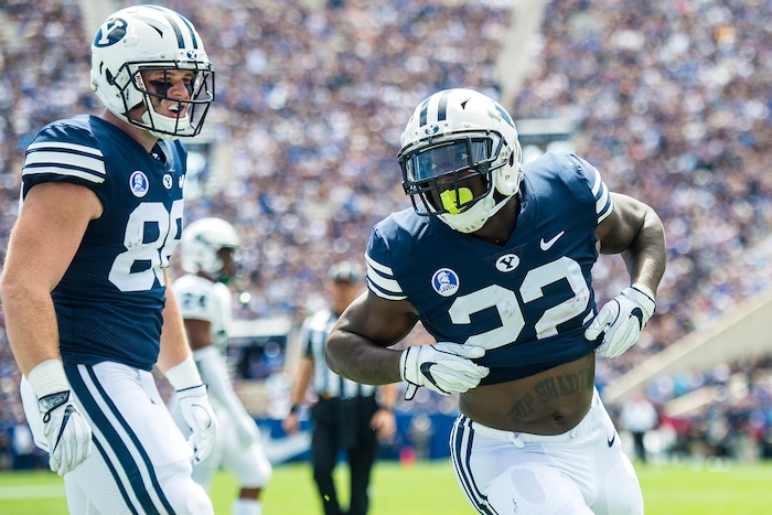 (Chris Detrick  |  The Salt Lake Tribune) Brigham Young Cougars running back Squally Canada (22) celebrates after scoring a touchdown during the game at LaVell Edwards Stadium Saturday, August 26, 2017. Brigham Young Cougars tight end Tanner Balderree (88) is at left.