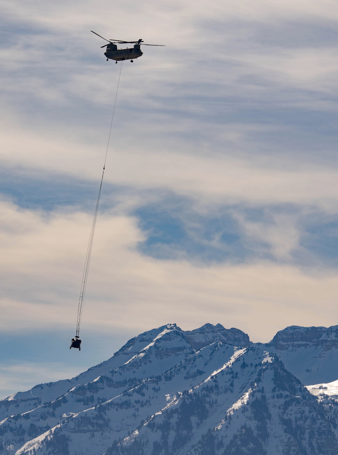 (Francisco Kjolseth | The Salt Lake Tribune) Recovery operations for two Utah Army National Guard UH-60 Black Hawk helicopters involved in a training accident in the Mineral Basin area last week are performed by a CH-47 Chinook helicopter and brought to the Heber Valley Airport on Wednesday, March 2, 2022.