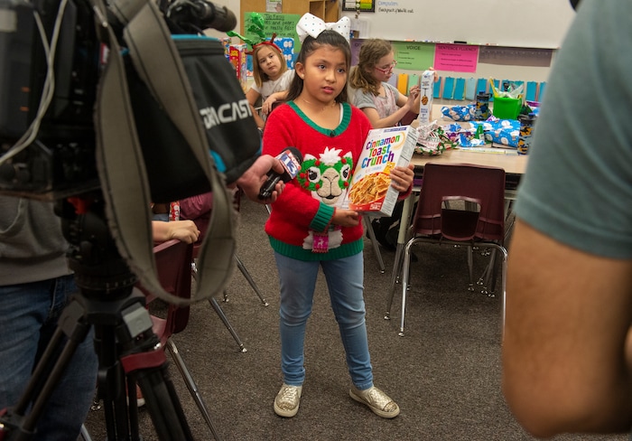 (Rick Egan  |  The Salt Lake Tribune)  Third grader Victoria Harwood, holds her box of cereal as she gives an interview to the media. Ms. Worthington the principal, surprised all 650 students at her school with the gift-wrapped boxes of cereal, at Oquirrh Elementary in West Jordan, Thursday, Dec. 20, 2018.


