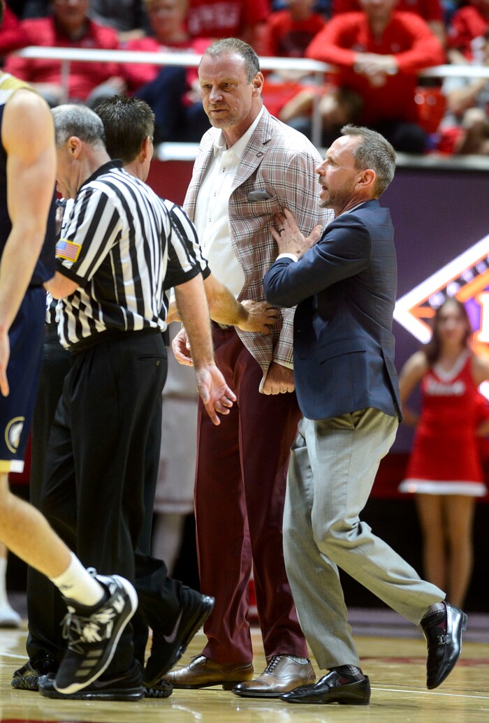 (Steve Griffin  |  The Salt Lake Tribune) University of Utah head coach  Larry Krystkowiak is held back by assistant  coach Tommy Connor as he screams at the ref during the Utah versus UC Davis men's NIT basketball game at the Huntsman Center in Salt Lake City Wednesday March 14, 2018. Krystkowiak was ejected from the game.
