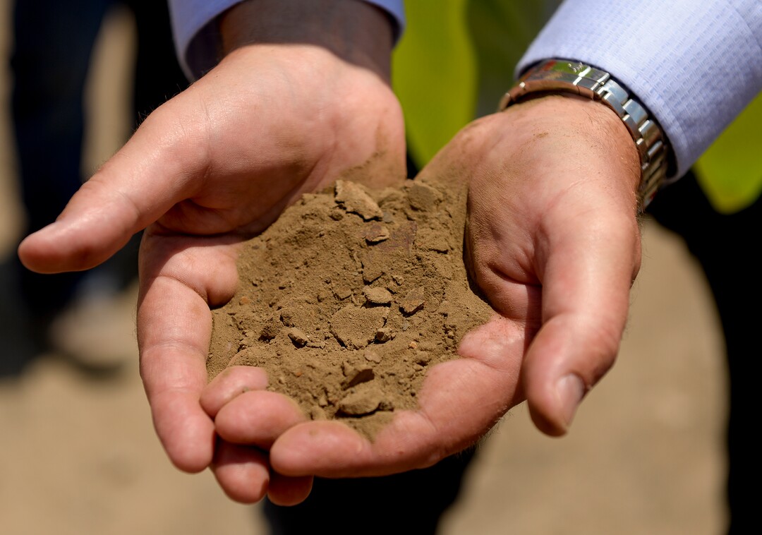 Leah Hogsten  |  The Salt Lake Tribune  Petroteq Energy CEO David Sealock holds a handful of clean, dry sand that was, minutes prior to processing, bitumen-rich tar sands at the company's Uinta Basin plant, Thursday, June 14, 2018. Petroteq claims to have  a patented process to extract crude oil from tar sands in a cost-effective, yet environmentally friendly manner using a proprietary cocktail of solvents. 