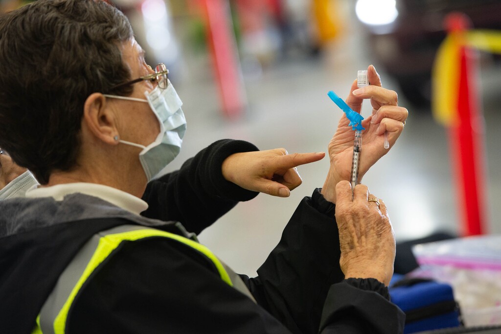 (Francisco Kjolseth | The Salt Lake Tribune) Registered nurse for Davis County Paula Johnson prepares the Pfizer vaccine as the Davis County School District begins COVID-19 vaccinations for its teachers at the Davis County Legacy Center in Farmington on Tuesday, Jan. 12, 2021.